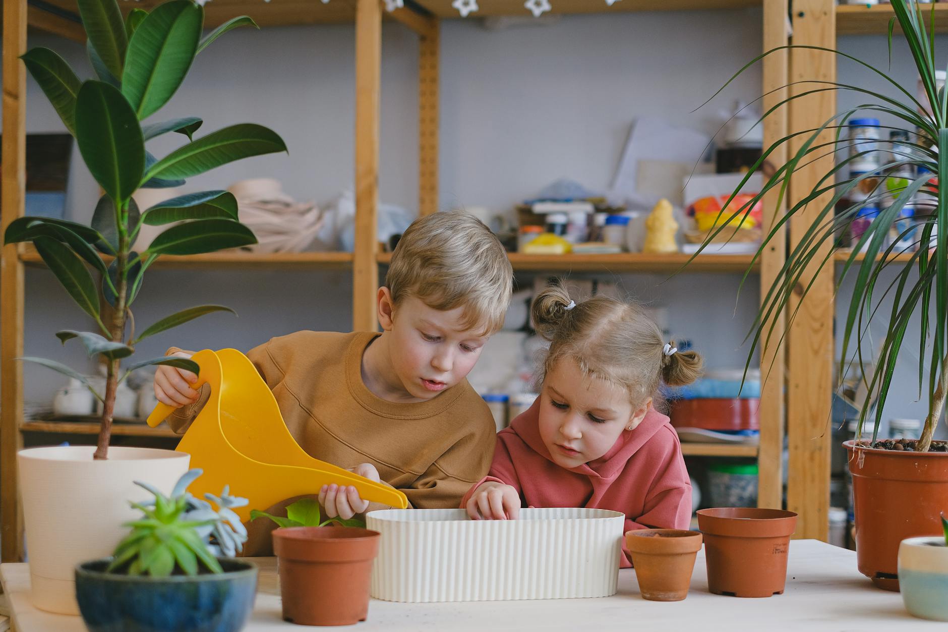 boy pouring water in a pot