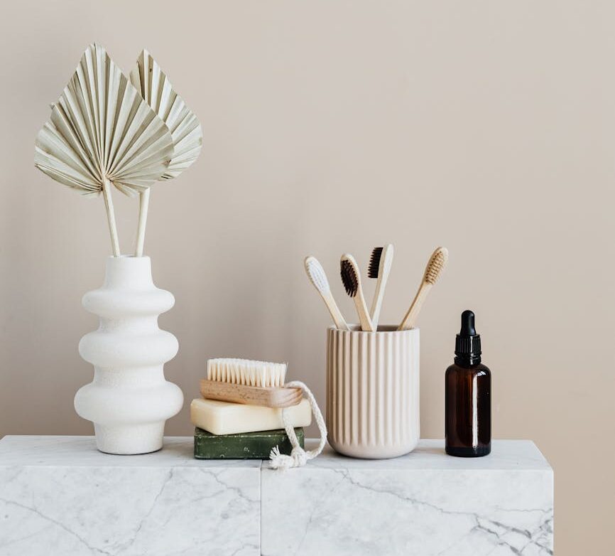 set of natural toiletries on marble table in bathroom